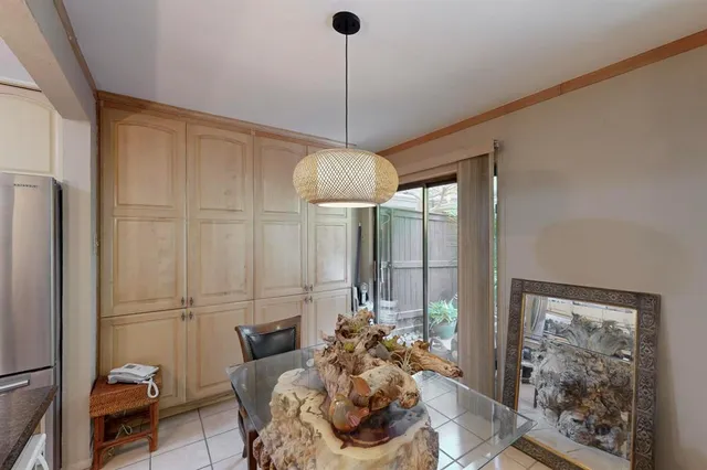 a living room with furniture a flat screen tv and a window