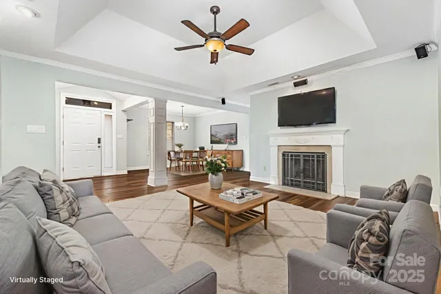 a view of empty room with wooden floor and fireplace