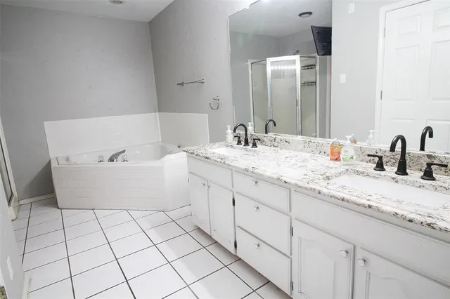 an empty room with windows and a ceiling fan