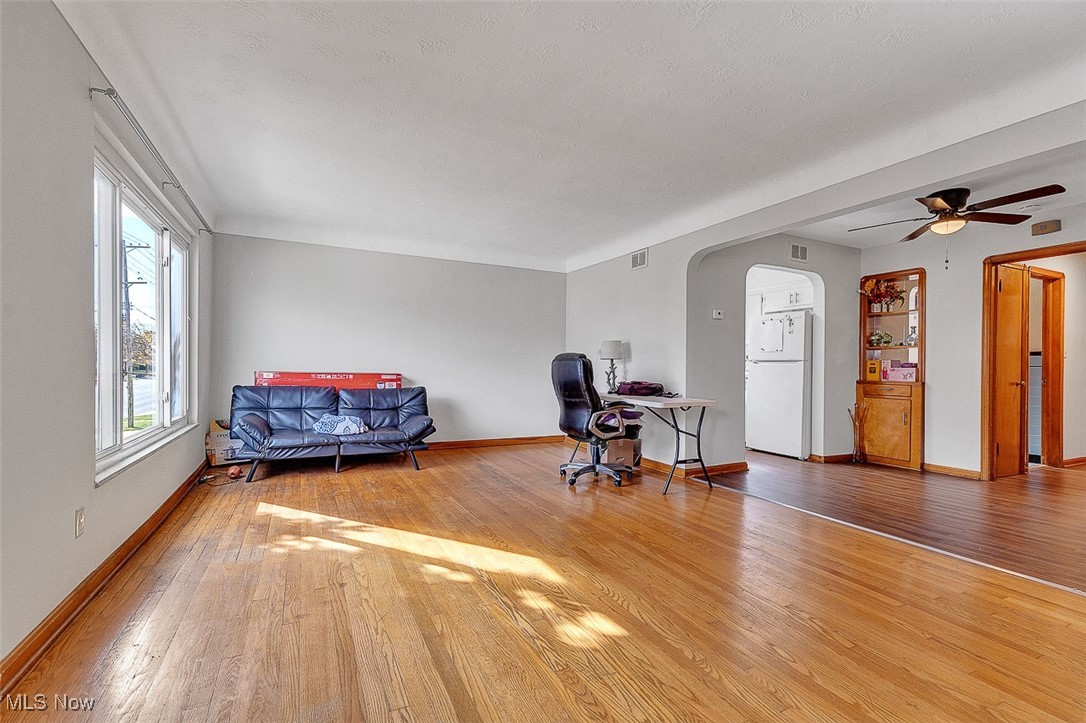 6136 Ridge Road Cleveland, OH 44129 - Photo 20 of 40 Sitting room with arched walkways, wood finished floors, an office area, and a ceiling fan