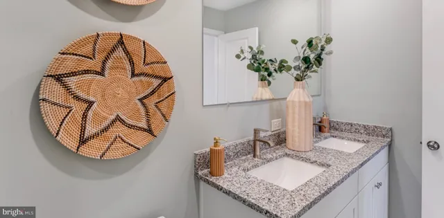 a bathroom with a granite countertop sink and a mirror