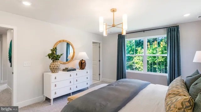 a bedroom with furniture and a window