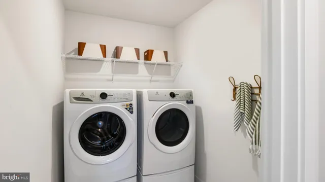 a close view of a utility room with dryer and washer