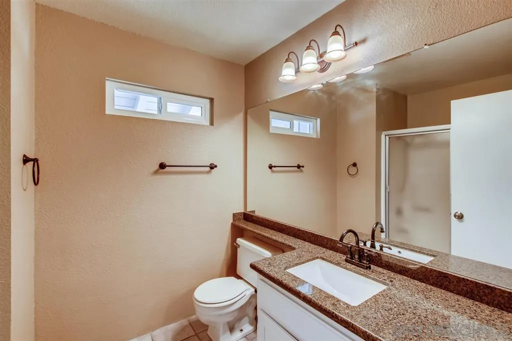 10411 Cadwell Road Santee, CA 92071 - Photo 21 of 25 a bathroom with a granite countertop sink mirror vanity and toilet