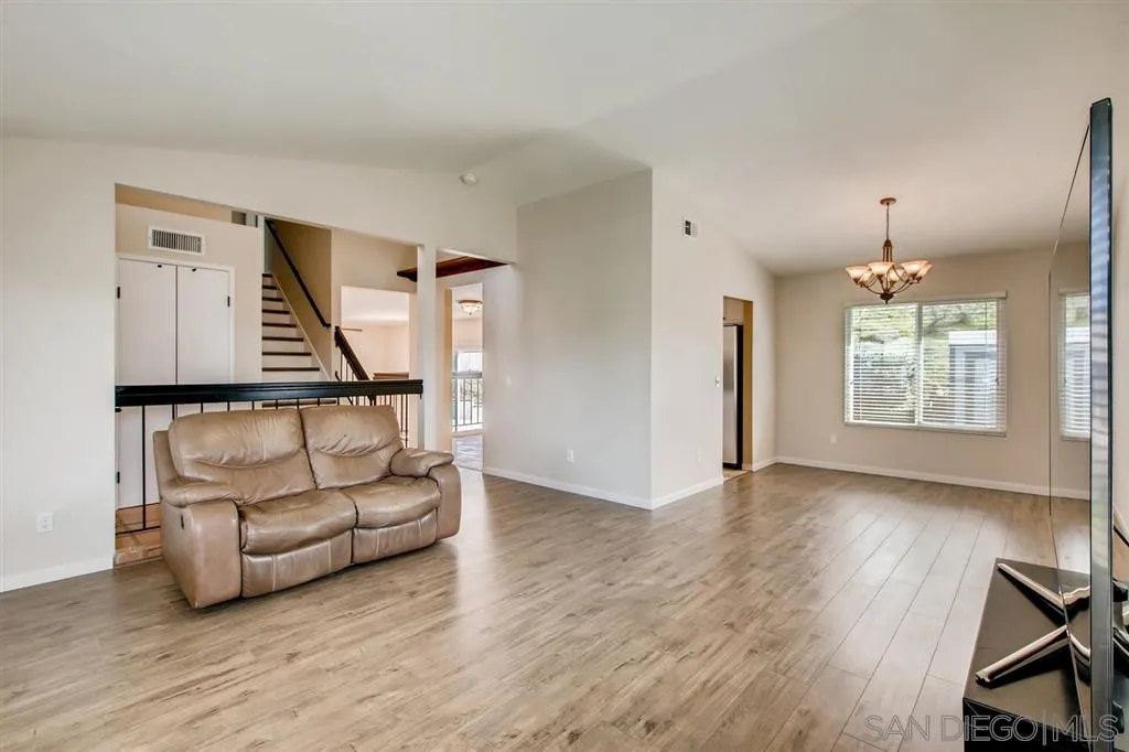 10411 Cadwell Road Santee, CA 92071 - Photo 4 of 25 a view of livingroom with furniture wooden floor windows and chandelier