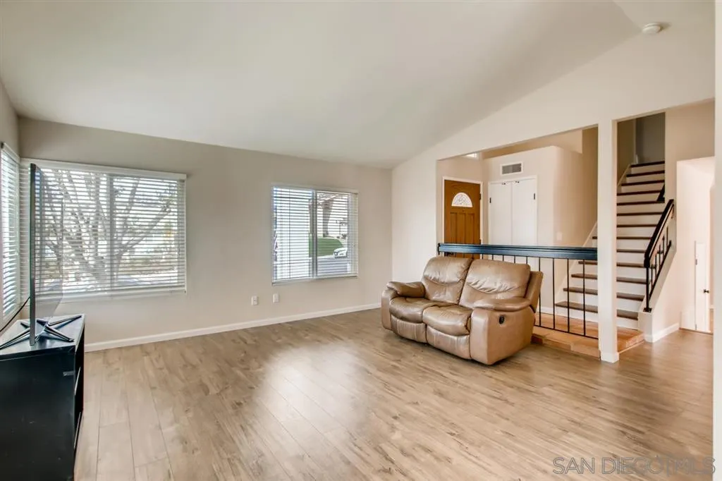 10411 Cadwell Road Santee, CA 92071 - Photo 5 of 25 an empty room with wooden floor and windows