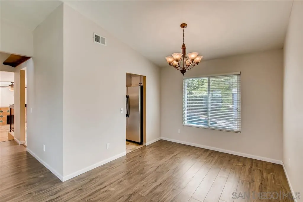 10411 Cadwell Road Santee, CA 92071 - Photo 7 of 25 an empty room with wooden floor and windows