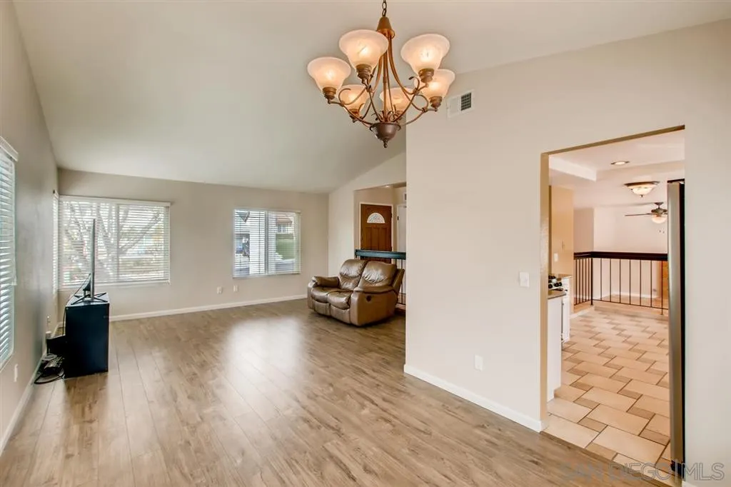 10411 Cadwell Road Santee, CA 92071 - Photo 8 of 25 a view of a livingroom with wooden floor and a chandelier