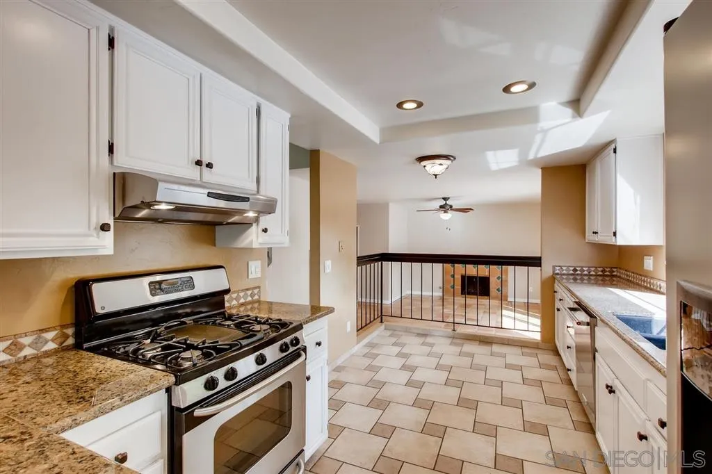 10411 Cadwell Road Santee, CA 92071 - Photo 9 of 25 a kitchen with granite countertop a stove and a sink