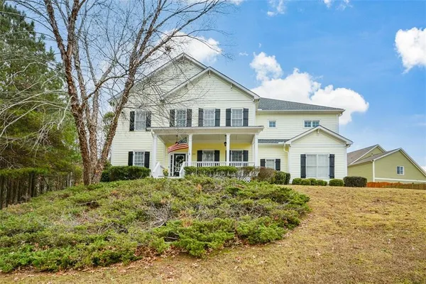 a front view of a house with a yard