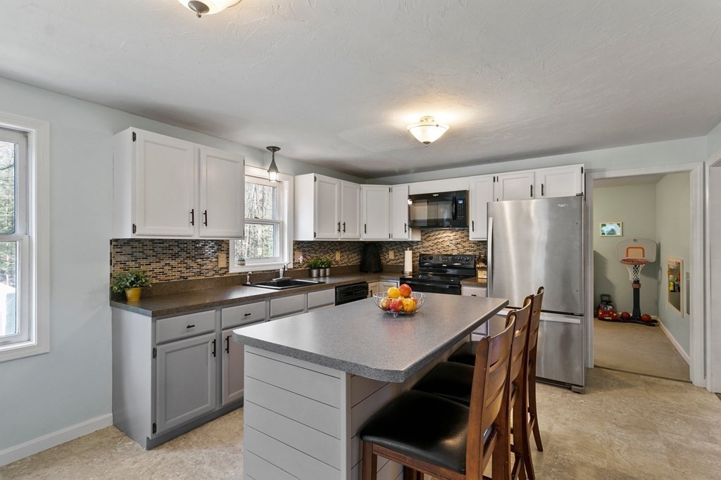 30 Butterworth Road Holland, MA 01521 - Photo 3 of 39 a kitchen with a sink a stove and chairs