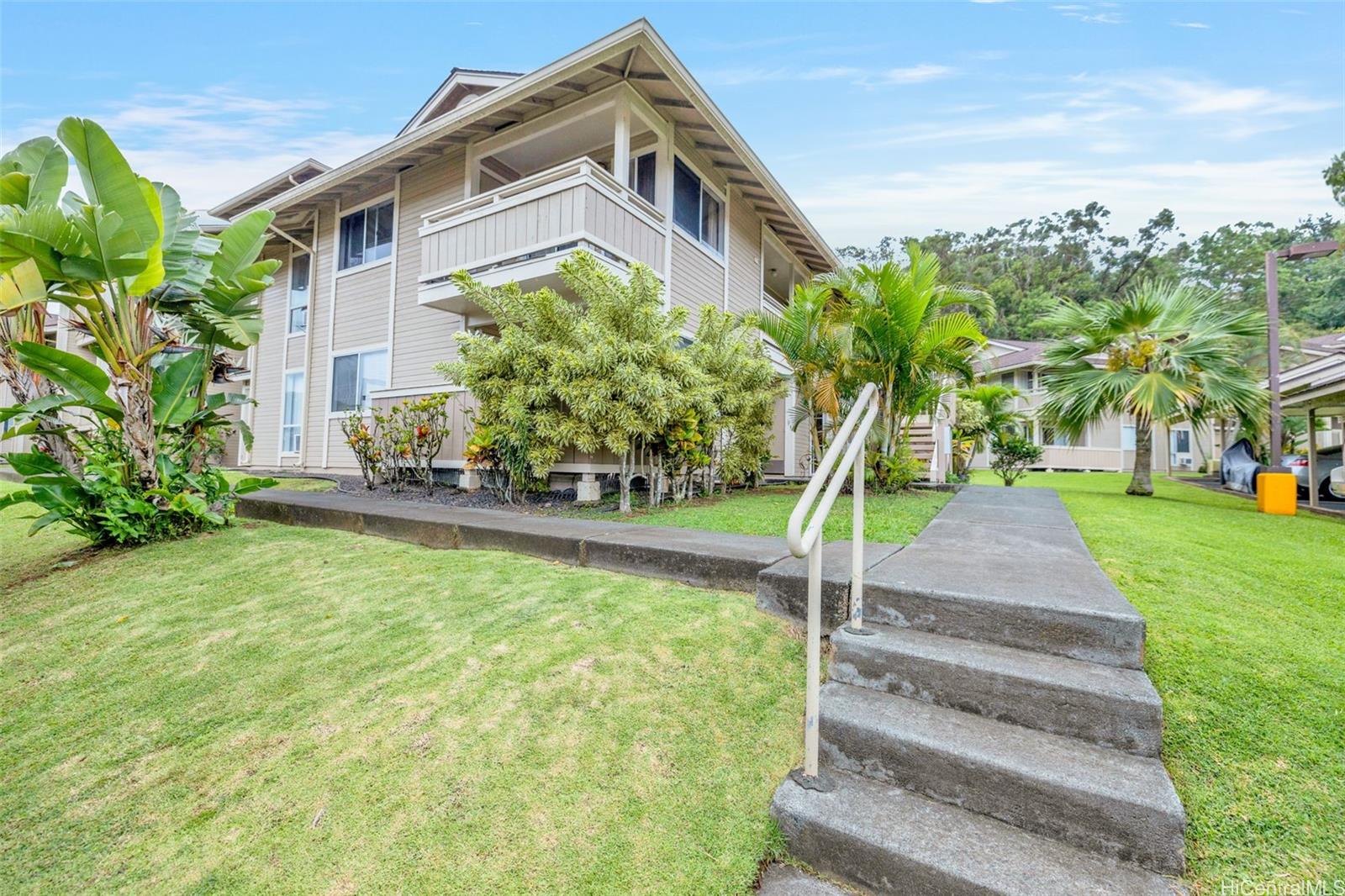 95-510 Wikao Street, Unit D205 Mililani, HI 96789 - Photo 1 of 1 a front view of a house with a yard and fountain
