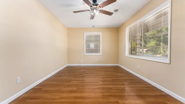 wooden floor in an empty room with a window