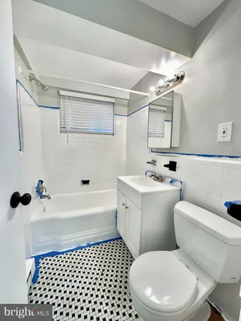 a bathroom with a toilet a sink and a shower