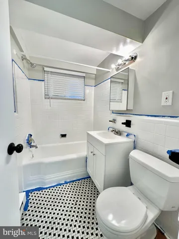 a bathroom with a toilet a sink and a shower
