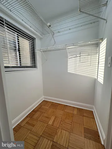 a view of a room with wooden floor and windows