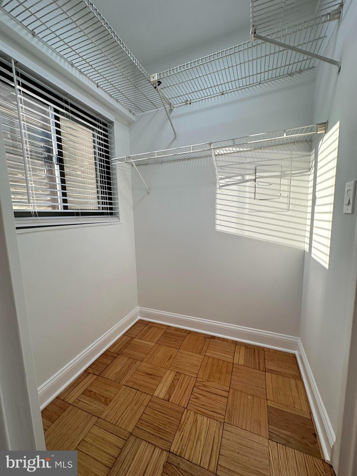 2141 I Street Northwest, Unit 702 Washington, DC 20037 - Photo 13 of 21 a view of a room with wooden floor and windows