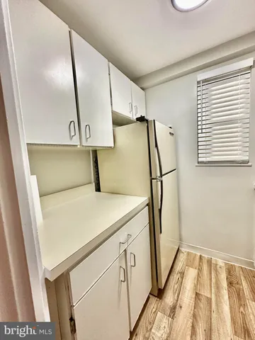 a hallway with sliding door and wooden door