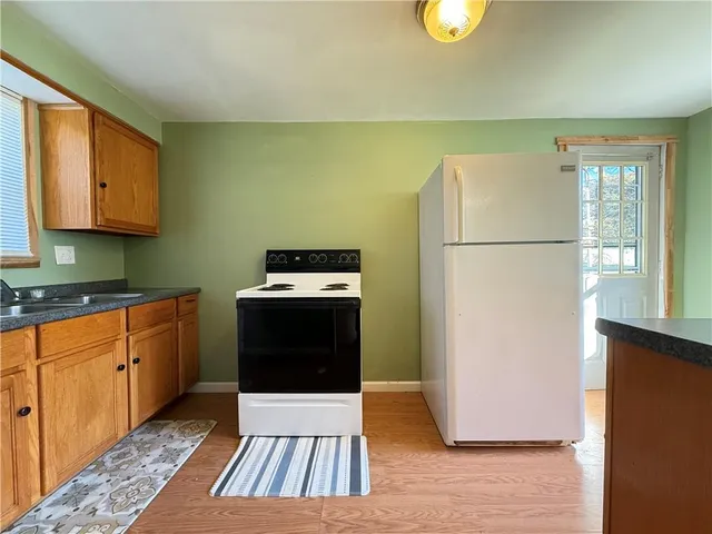 a view of a room with wooden floor and a window