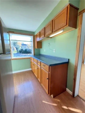 a view of a room with wooden floor and a window