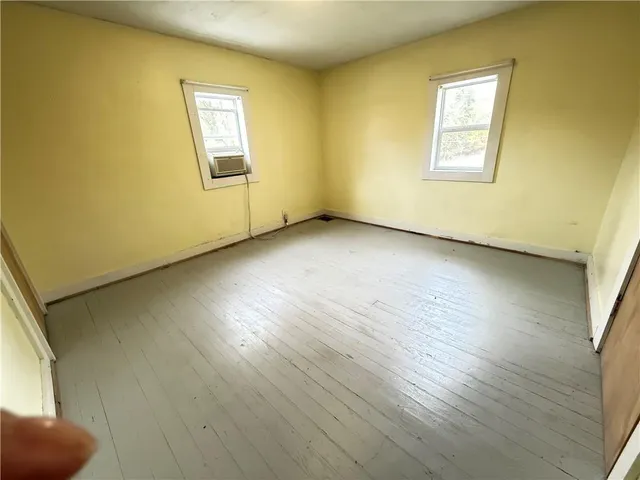 a bathroom with a toilet a sink and a window