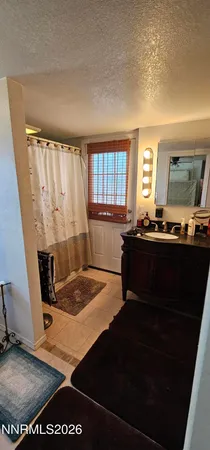 a living room with table chairs and a window