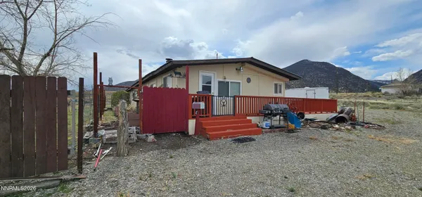 a view of a house with a yard and sitting area