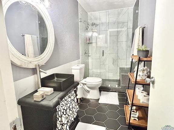 211 Paris Street Longview, TX 75604 - Photo 3 of 15 a bathroom with a toilet a sink and a mirror