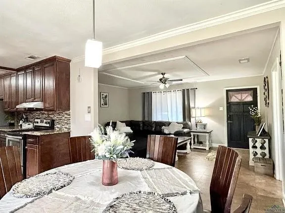 a dining room with wooden floor a chandelier a wooden table and chairs