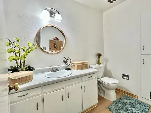 a bathroom with a toilet a sink and a mirror