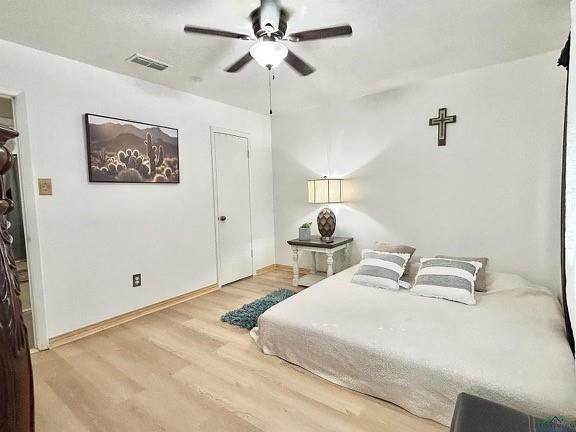 211 Paris Street Longview, TX 75604 - Photo 10 of 15 a bedroom with a bed and a chandelier