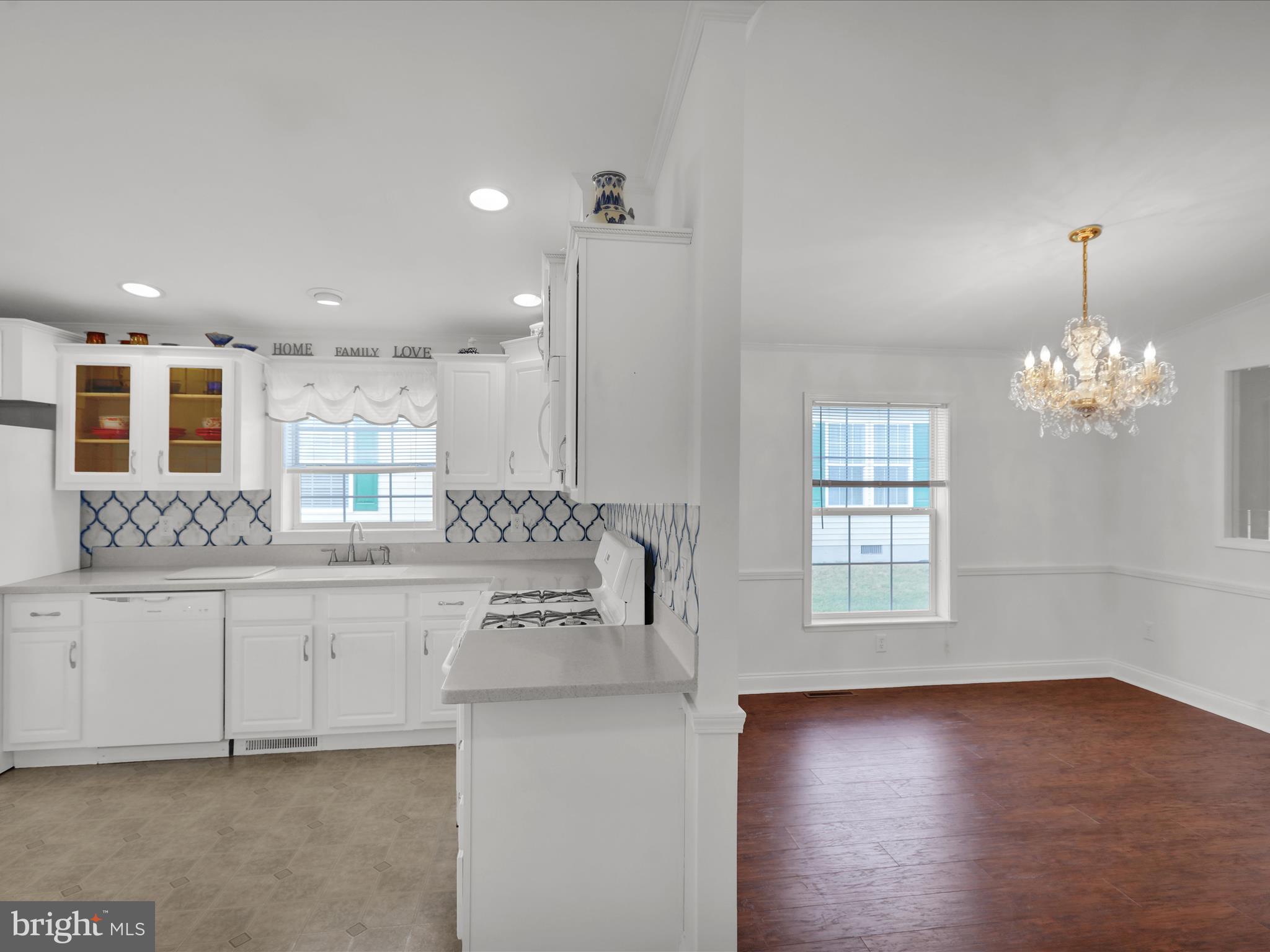 25 Random Road Douglassville, PA 19518 - Photo 16 of 41 a view of a kitchen with kitchen island a sink wooden floor and a chandelier
