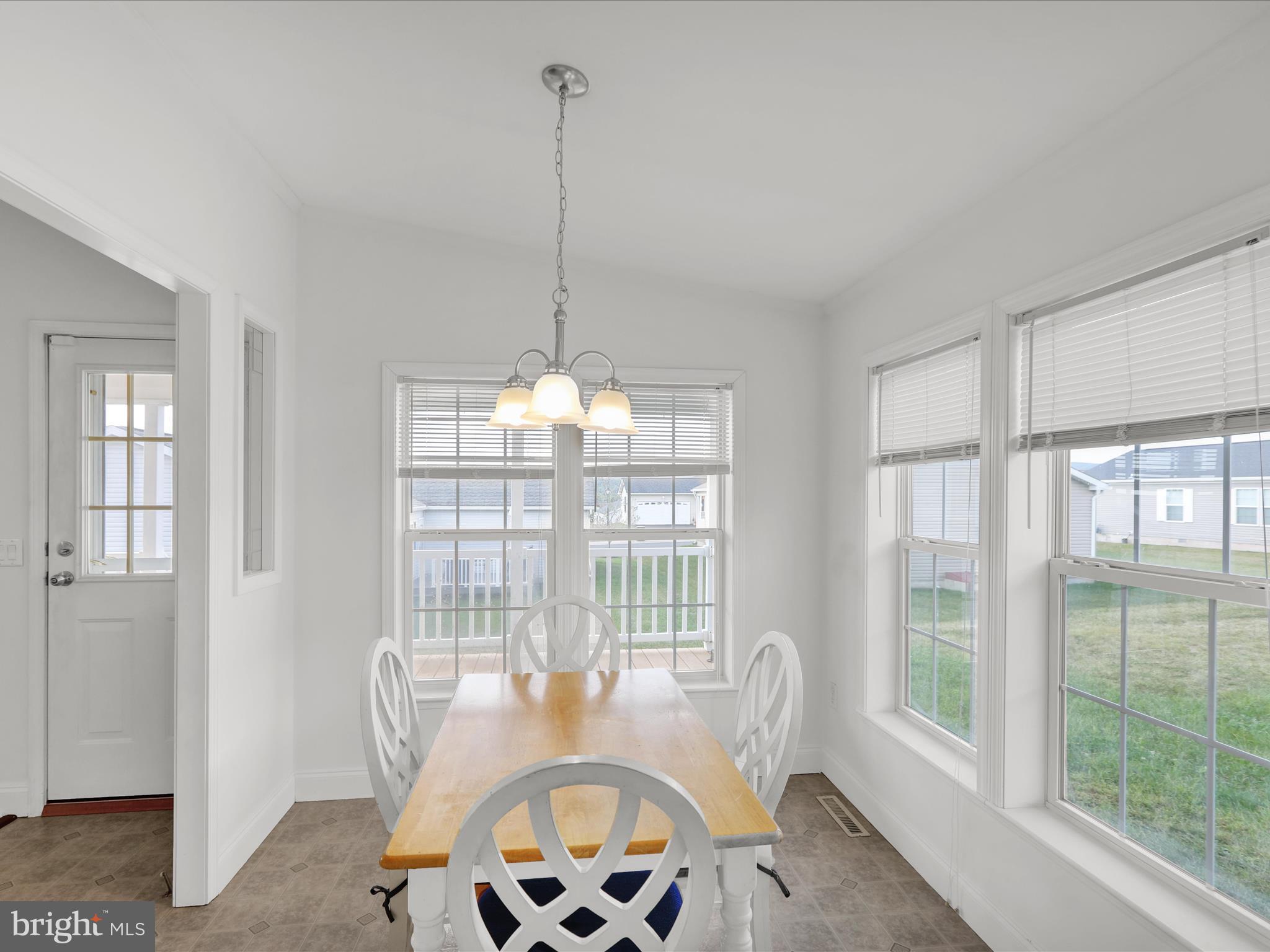 25 Random Road Douglassville, PA 19518 - Photo 21 of 41 a view of a dining room with furniture wooden floor and a chandelier