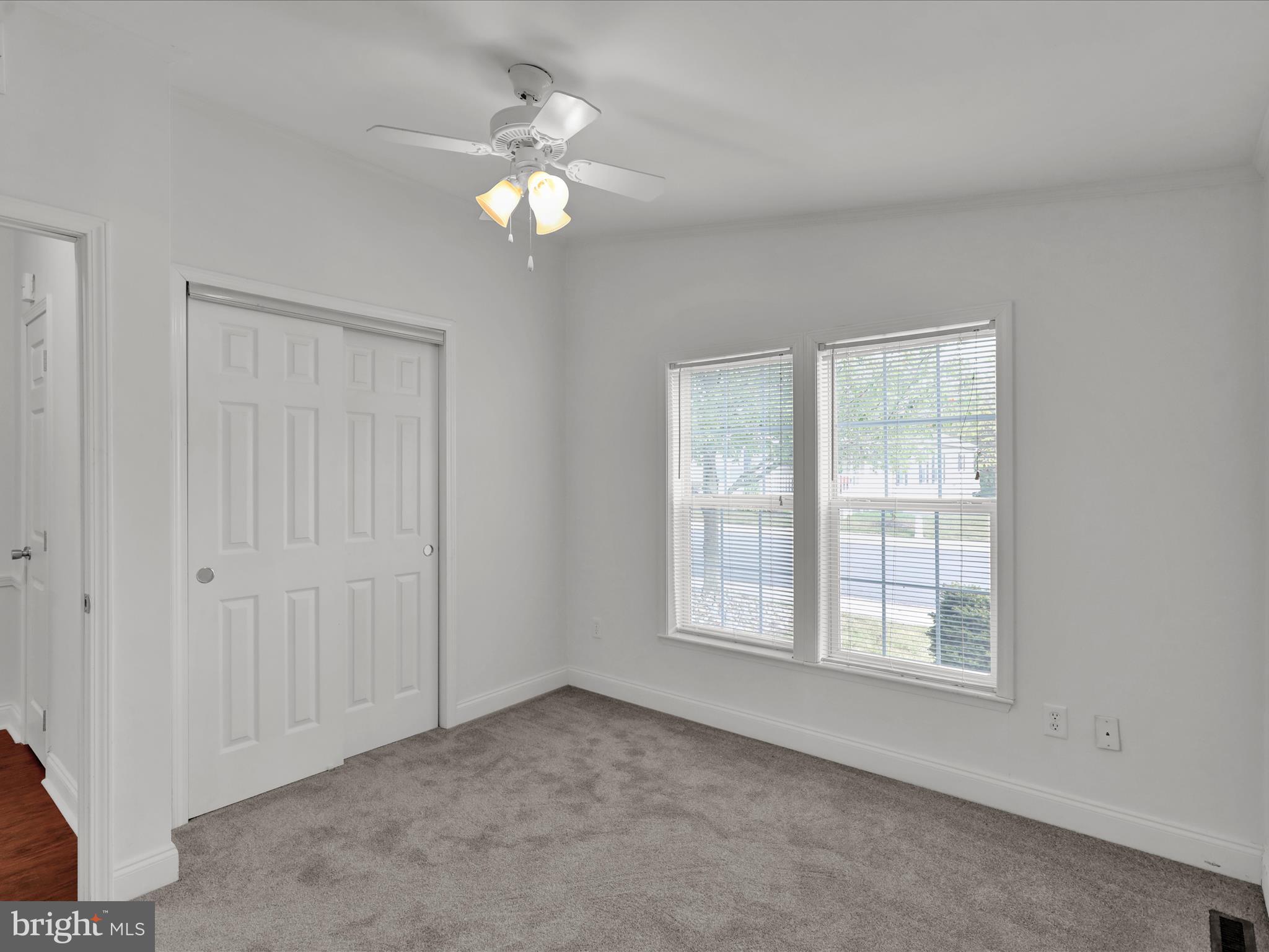 25 Random Road Douglassville, PA 19518 - Photo 39 of 41 an empty room with chandelier fan and windows