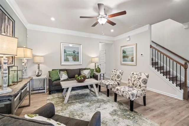 a living room with furniture and wooden floor