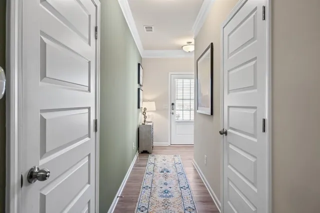 a view of entryway and hall with wooden floor