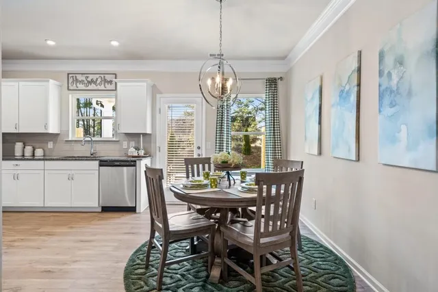 a kitchen with granite countertop white cabinets and stainless steel appliances