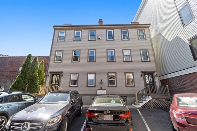 a front view of a house with parking space