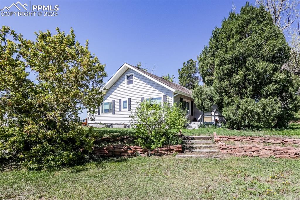 6597 Highway 83 Franktown, CO 80116 - Photo 2 of 48 a front view of a house with a yard