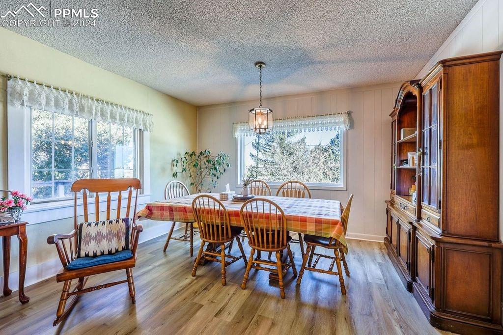 6597 Highway 83 Franktown, CO 80116 - Photo 21 of 48 a view of a dining room with furniture window and wooden floor