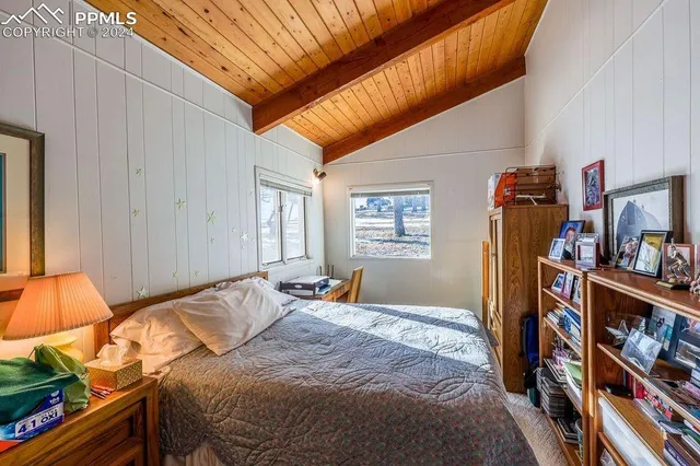 a bedroom with a bed and a book shelf