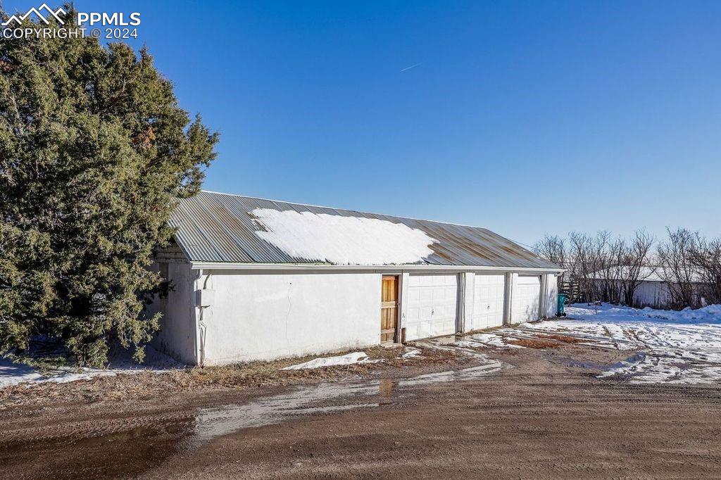 6597 Highway 83 Franktown, CO 80116 - Photo 29 of 48 a front view of a house with a yard and garage