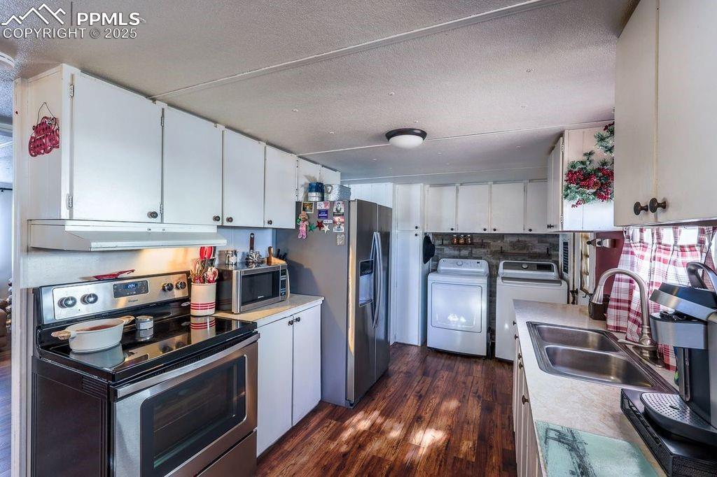 6597 Highway 83 Franktown, CO 80116 - Photo 31 of 48 a kitchen with stainless steel appliances granite countertop a stove refrigerator and a sink