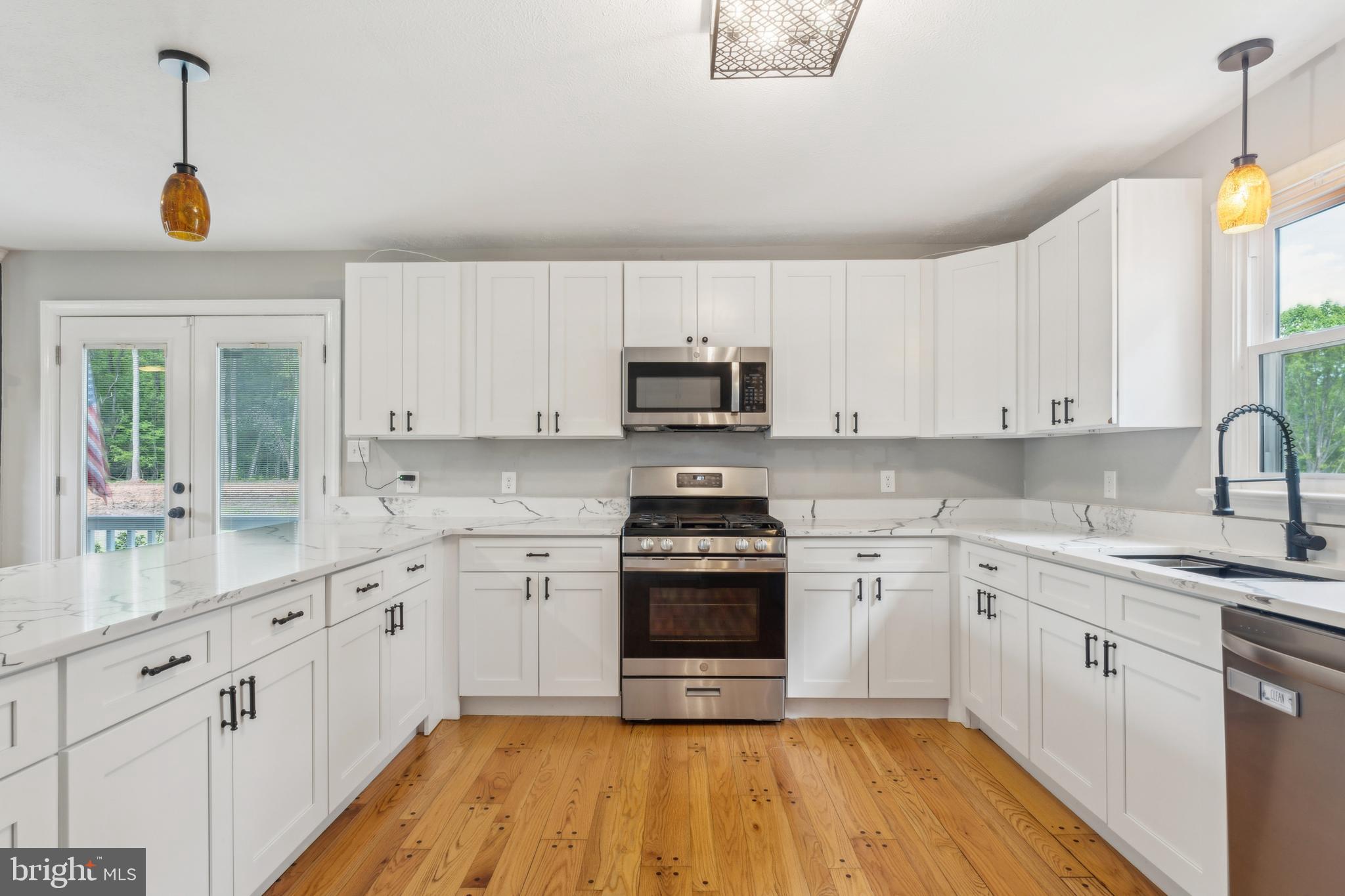19316 Landora Bridge Road Ruther Glen, VA 22546 - Photo 3 of 35 a kitchen with cabinets stainless steel appliances a sink and a stove