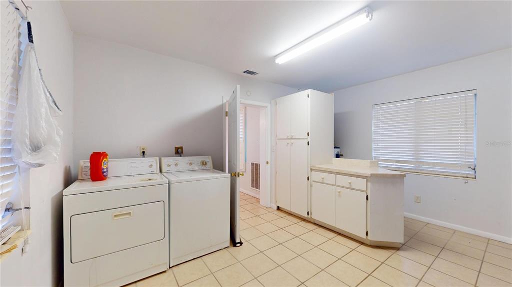 121 North Seminole Avenue Inverness, FL 34450 - Photo 13 of 47 a utility room with cabinets washer and dryer