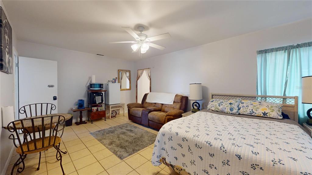 121 North Seminole Avenue Inverness, FL 34450 - Photo 16 of 47 a bedroom with two beds and a chandelier
