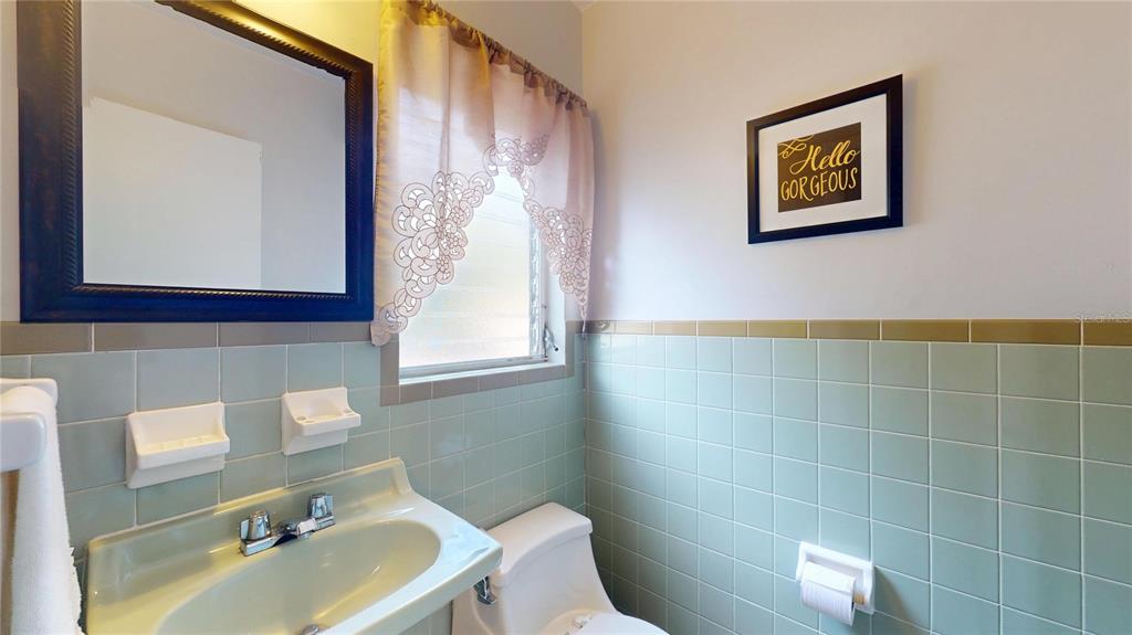 121 North Seminole Avenue Inverness, FL 34450 - Photo 21 of 47 a bathroom with a sink a toilet and mirror