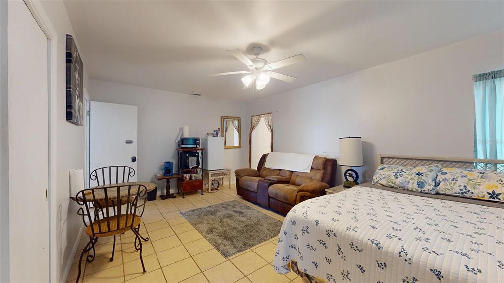 121 North Seminole Avenue Inverness, FL 34450 - Photo 22 of 47 a bedroom with two beds and a chandelier
