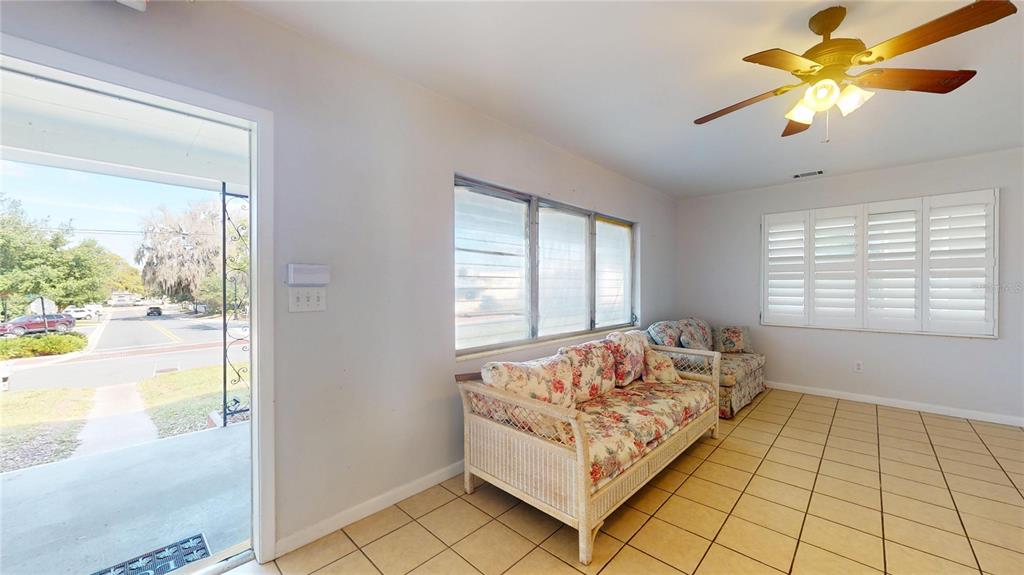121 North Seminole Avenue Inverness, FL 34450 - Photo 3 of 47 a spacious bedroom with a bed and a chandelier fan