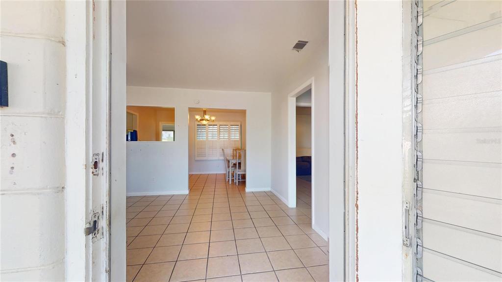 121 North Seminole Avenue Inverness, FL 34450 - Photo 4 of 47 a view of a hallway with wooden floor and a living room